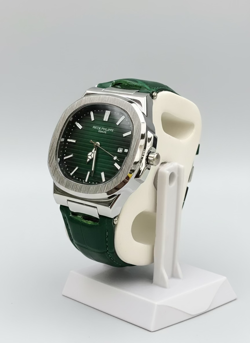 Green watch with a detailed face on a white stand against a green leafy background